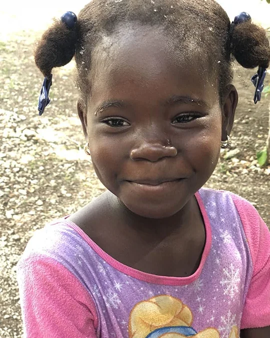 A young HEART student smiling