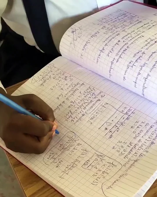 A student writing in her notebook