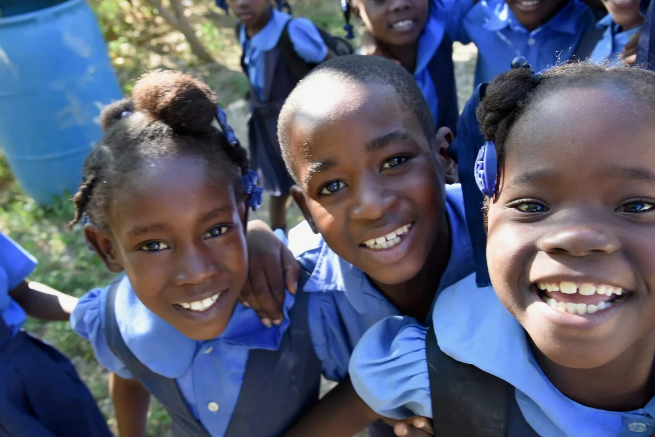 HEART students smiling together in their blue school uniforms